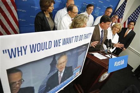 U.S. Representative Todd Rokita (R-IN) (4th R, in brown suit at microphones) speaks about his son's rare medical condition "Angelman Syndrome", during a news conference about restoring National Institutes of Health funding, at the U.S. Capitol in Washington, October 3, 2013. REUTERS/Jonathan Ernst