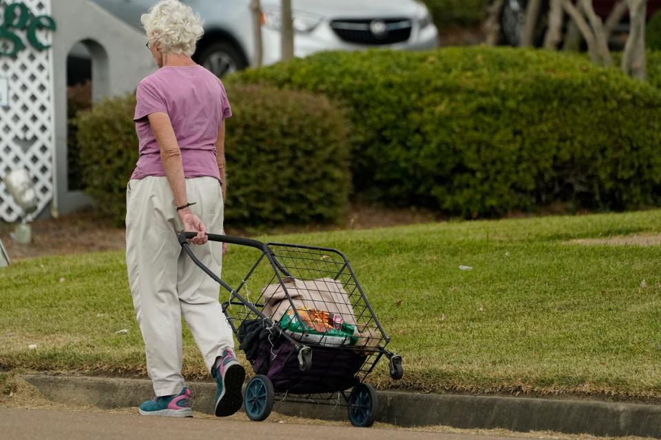 An older customer walks home after shopping in Jackson, Miss., on Oct. 12, 2022. Cost-of-living adjustment, or COLA, will boost the average monthly checks retirees receive in 2023 by $146 to $1,827, the Social Security Administration said on Oct. 13, 2022.