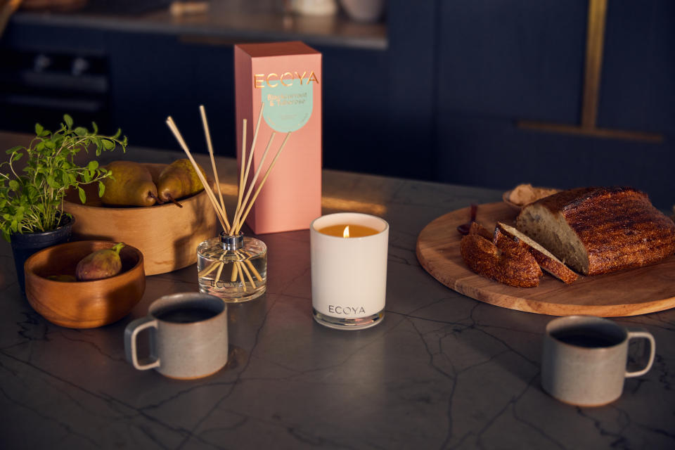 A modern kitchen bench featuring the Ecoya Blackcurrant and Tuberose reed diffuser and candle