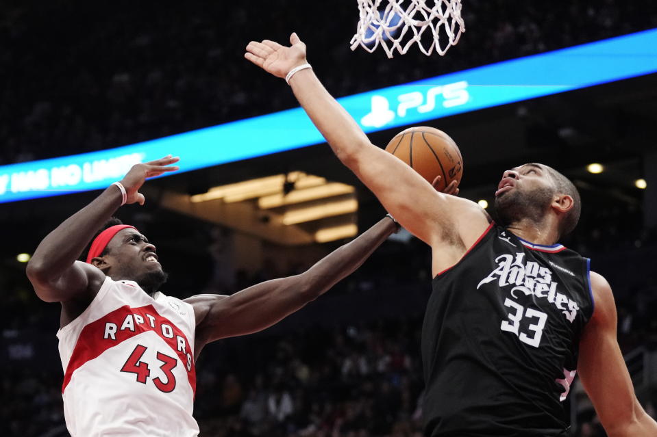 Toronto Raptors forward Pascal Siakam (43) drives to the basket as Los Angeles Clippers forward Nicolas Batum (33) defends during the second half of an NBA basketball game Tuesday, Dec. 27, 2022, in Toronto. (Frank Gunn/The Canadian Press via AP)