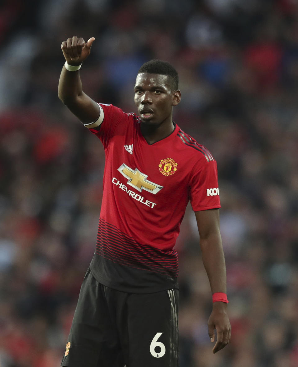 Manchester United's Paul Pogba gives a thumbs up to a teammate during the English Premier League soccer match between Manchester United and Leicester City at Old Trafford, in Manchester, England, Friday, Aug. 10, 2018. (AP Photo/Jon Super)