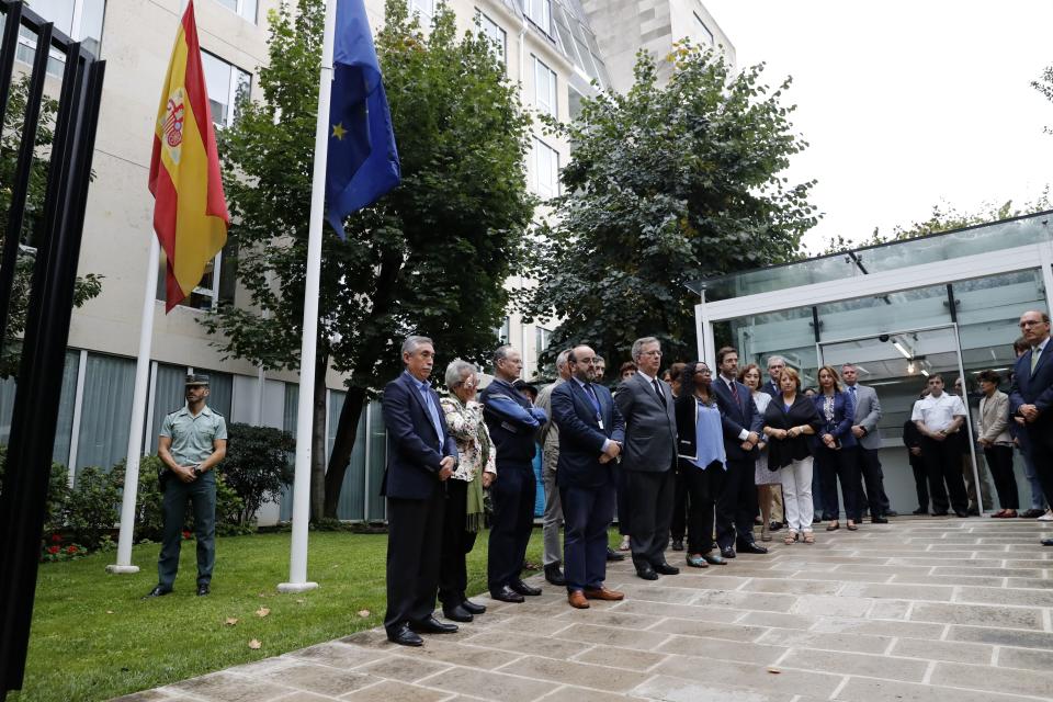 Staff members of the Embassy of Spain in Paris observe a minute of silence.&nbsp;