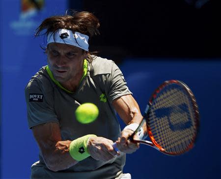 David Ferrer of Spain hits a return to Jeremy Chardy of France during their men's singles match at the Australian Open 2014 tennis tournament in Melbourne January 17, 2014. REUTERS/Petar Kujundzic