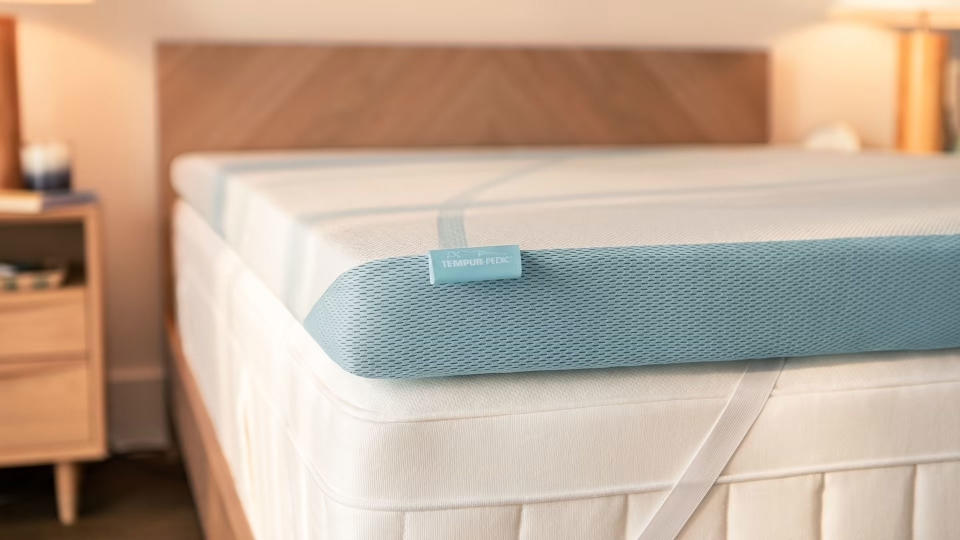 The Tempur-Pedic TEMPUR-Adapt mattress topper on a bed