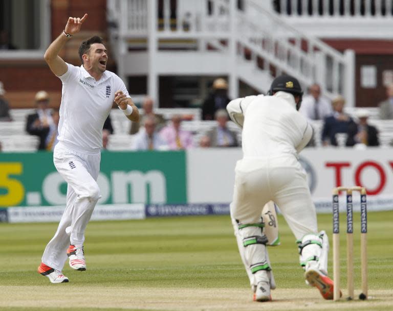 England's James Anderson celebrates taking the wicket of New Zealand's Martin Guptill (R) on the fifth day of their first cricket Test match at Lord's cricket ground in London on May 25, 2015