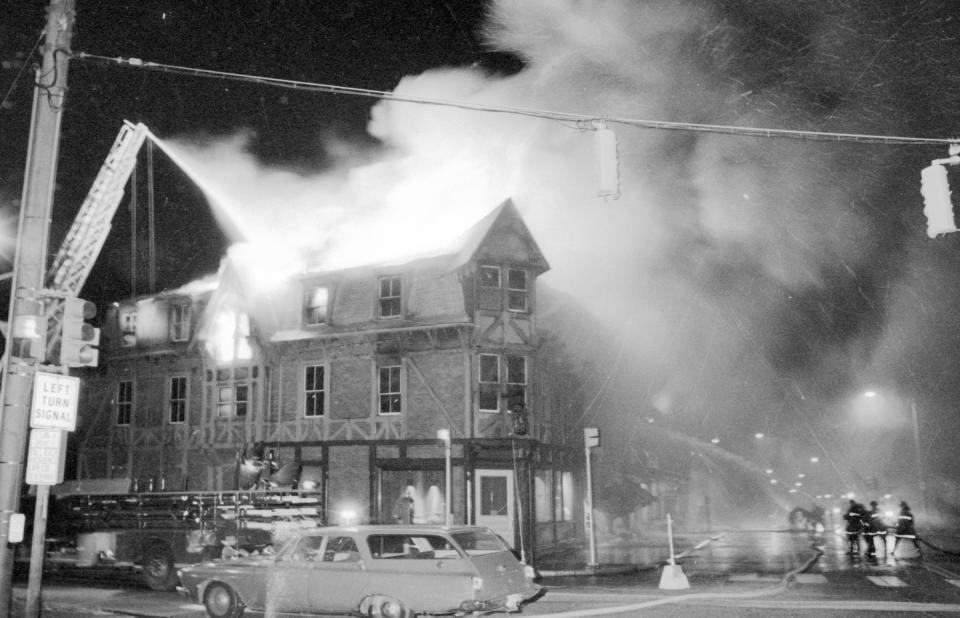 Members of the Newport Fire Department battle a blaze at the corner of Memorial Boulevard and Bellevue Avenue in this photo from Nov. 4, 1972. According to an account in The Providence Journal, nearly 100 firefighters were on scene as "thousands of persons emerged from cars, nearby restaurants, cafes and homes to watch the fire."
