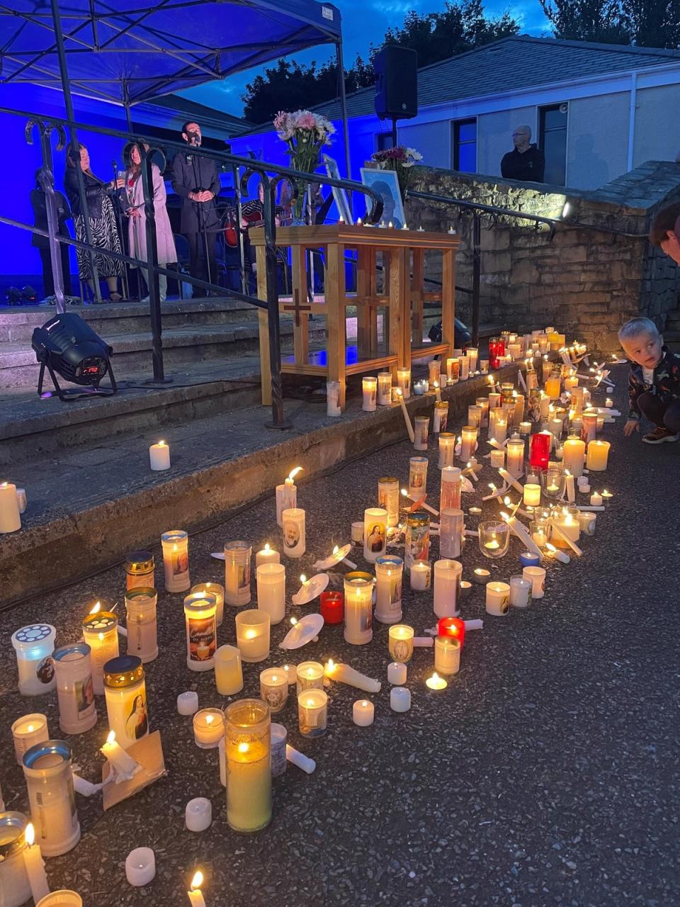 Candles are lit at St Oliver Plunkett church (Jonathan McCambridge/PA) (PA Wire)