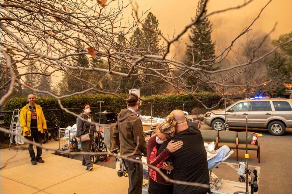 Nurse Cassie Lerossignol hugs a coworker as the Feather River Hospital burns while the Camp Fire rages through Paradise, Calif., on Nov. 8.