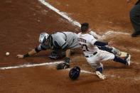 Oct 14, 2017; Houston, TX, USA; Houston Astros second baseman Jose Altuve (27) crosses home plate for the winning run as New York Yankees catcher Gary Sanchez (24) reaches for the ball during the ninth inning in game two of the 2017 ALCS playoff baseball series at Minute Maid Park. Mandatory Credit: Troy Taormina-USA TODAY Sports