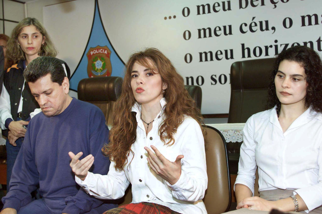 Former Mexican pop star Gloria Trevi (C) speaks alongside her manager Sergio Andrade (L) and backup singer Maria Raquenel Portillo during a news conference at Federal Police headquarters in Brasilia December 5, 2000. Teary-eyed and desperate, the fallen pop star made an impashioned plea to human rights groups to help her prove her innocence from sexual abuse charges just days ahead of her extradition hearing in Brazil. It was the first time the trio, who all face similar extradition hearings, spoke to the media since their arrest last January.    JB