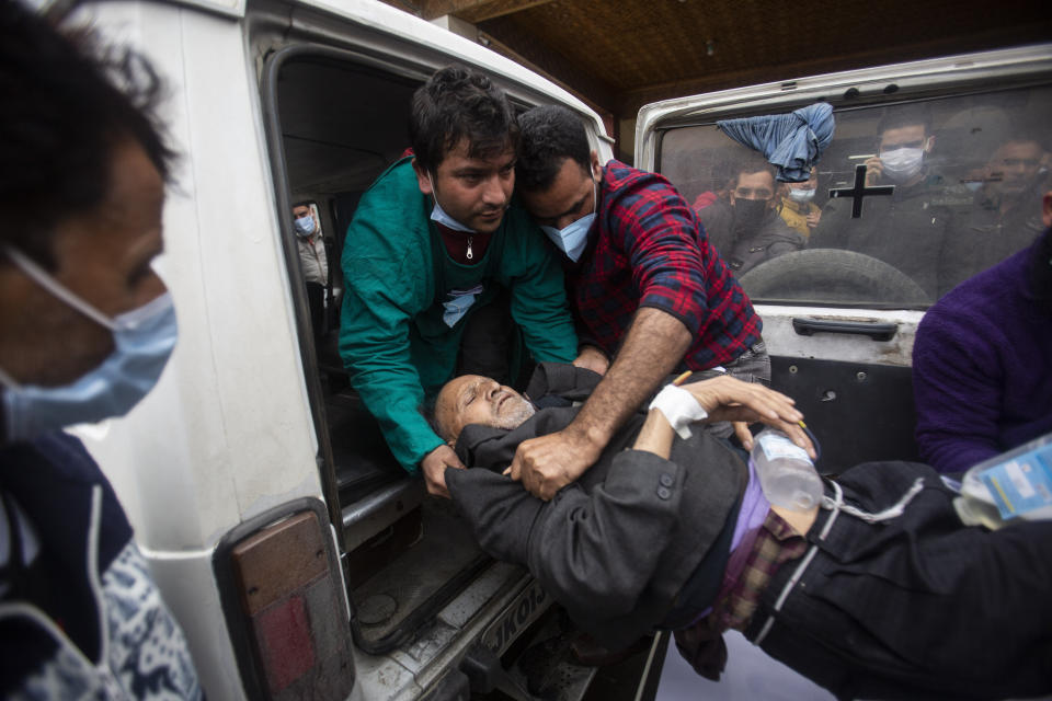 A Kashmiri man injured in an attack is brought for treatment at a hospital in Srinagar, Indian controlled Kashmir, Monday, March. 29, 2021. Gunmen killed an elected official of India’s ruling party and a policeman in disputed Kashmir on Monday, police said. (AP Photo/Mukhtar Khan)