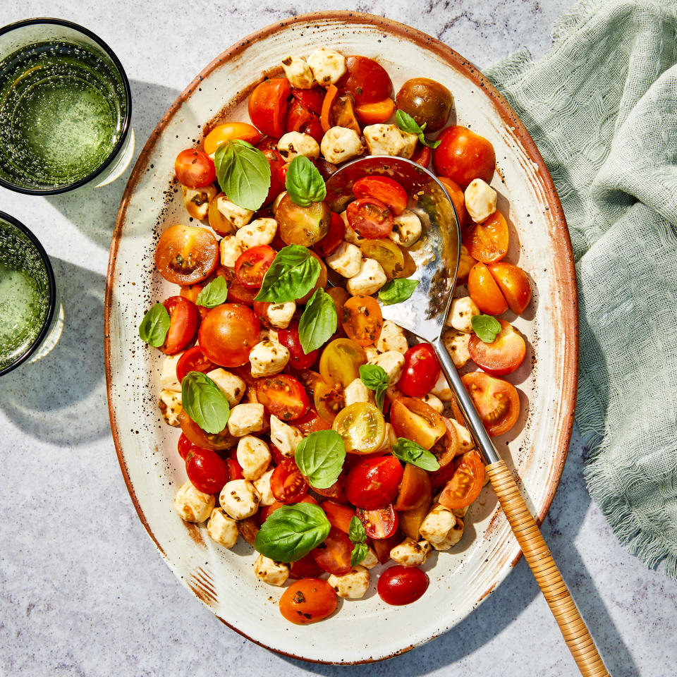 <p>The basil dressing packs a punch in this caprese salad with cherry tomatoes. Dark balsamic vinegar is traditional, but to make the color pop, white balsamic vinegar can be used in its place. <a href="https://www.eatingwell.com/recipe/7951379/caprese-salad-with-cherry-tomatoes/" rel="nofollow noopener" target="_blank" data-ylk="slk:View Recipe" class="link ">View Recipe</a></p>
