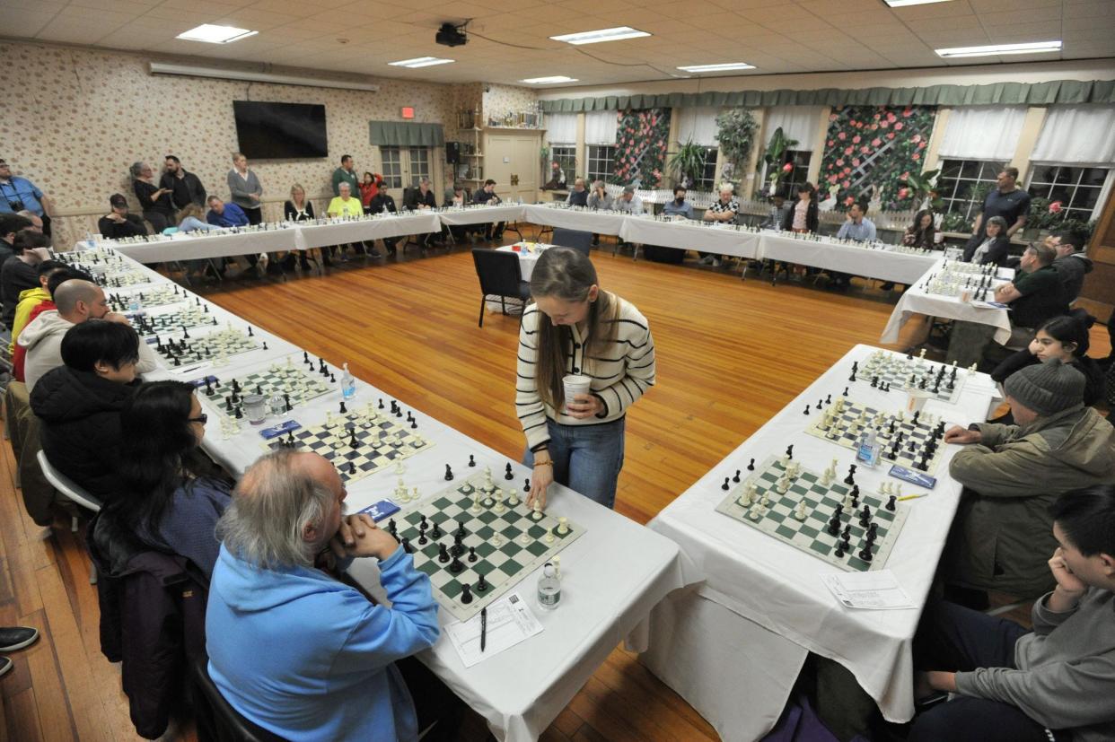 Chess Grandmaster Nadya Kosintseva, standing center, competes with over 30 amateurs during a simul at the South Shore Chess Club in Quincy, Wednesday, March 27, 2024.