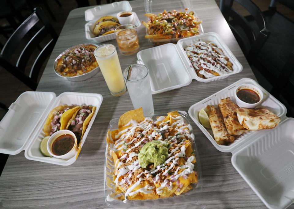 Chicken Tinga Nachos is front and center on a table of delicious dishes at the new TacoDero.