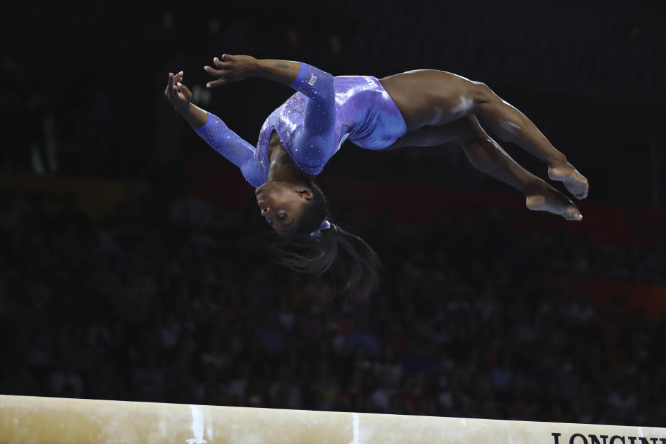 Gold medalist Simone Biles of the United States performs on the balance beam in the women's apparatus finals at the Gymnastics World Championships in Stuttgart, Germany, Sunday, Oct. 13, 2019. (AP Photo/Matthias Schrader)