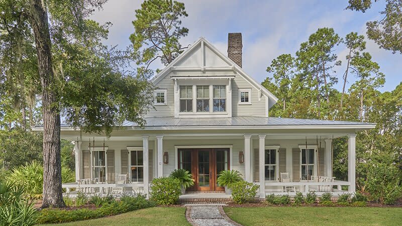 Lowcountry Farmhouse with porch swings set back into trees