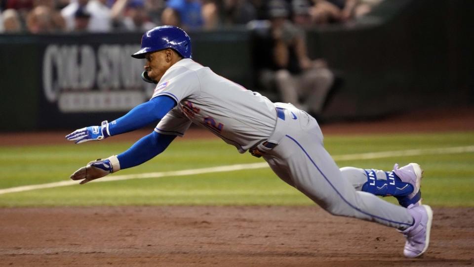 July 6, 2023;  Phoenix, Arizona, USA;  New York Mets shortstop Francisco Lindor (12) dives into third base for a triple against the Arizona Diamondbacks during the third inning at Chase Field.