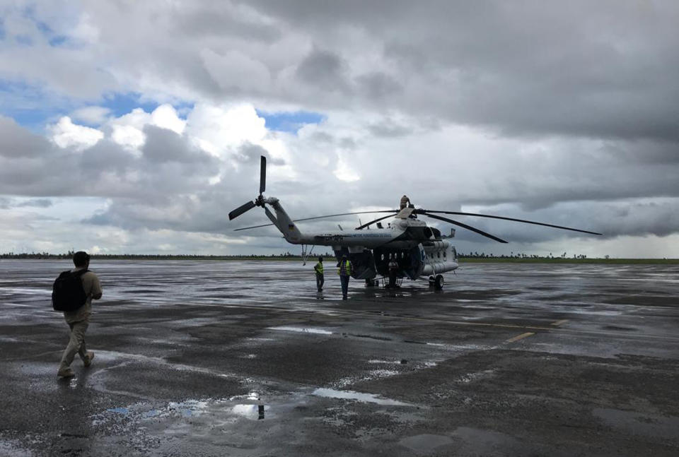 A UN humanitarian helicopter prepares for a day of work, at the airport in the Mozambique city of Beira, Friday March 22 2019. Some hundreds of people are dead, many more still missing and with many thousands at risk from massive flooding in Mozambique, Malawi and Zimbabwe caused by Cyclone Idai. (AP Photo/Cara Anna)