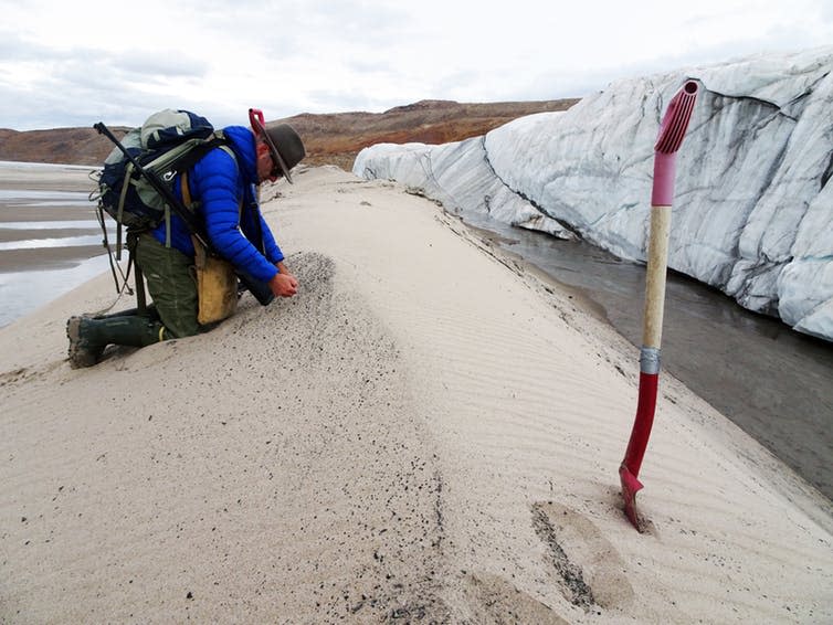 <span class="caption">Kurt Kjær collecting sand samples at the front of Hiawatha Glacier.</span> <span class="attribution"><span class="source">Svend Funder</span></span>