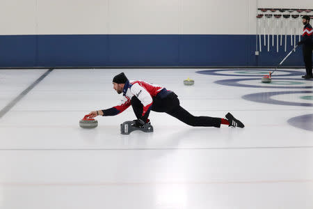 Former Minnesota Vikings defensive end Jared Allen throws a stone during the USA Curling Men's Challenge Round in Blaine, Minnesota, U.S., January 3, 2019. All Pro Curling/Handout via REUTERS