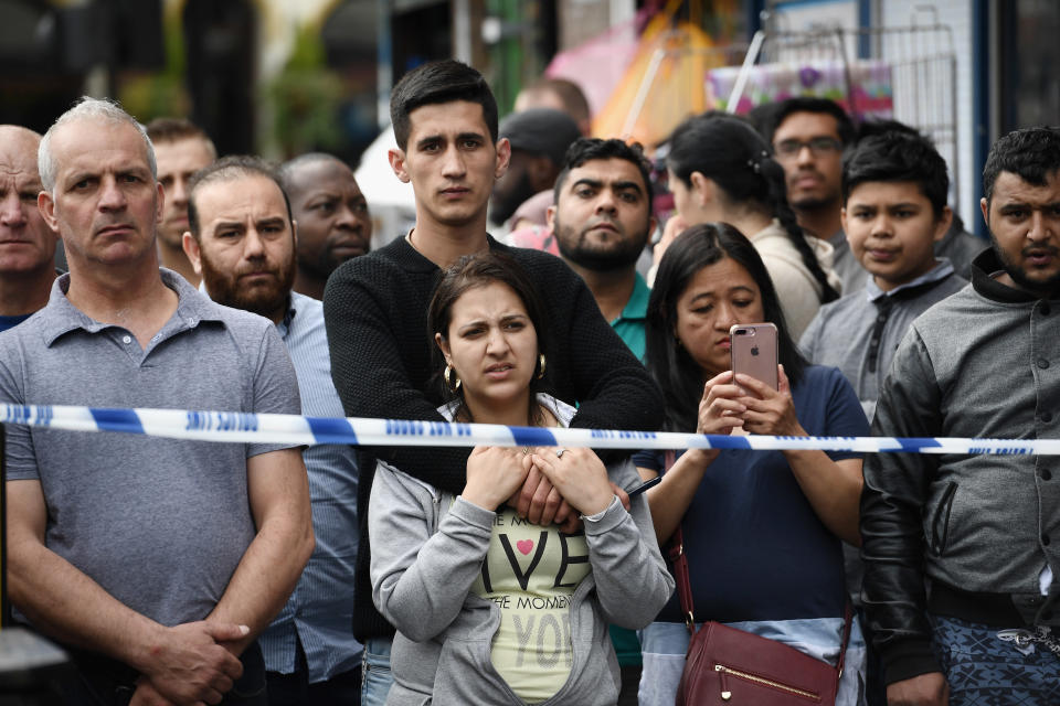 Members of the public view the scene after police officers raided a property in East Ham in London, England.&nbsp;