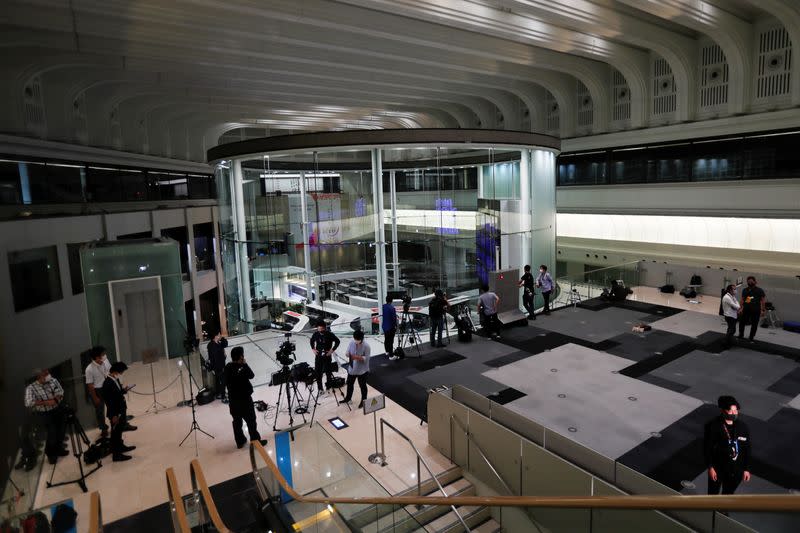 Members of the media are seen working at the empty Tokyo Stock Exchange (TSE) after the TSE temporarily suspended all trading due to system problems in Tokyo