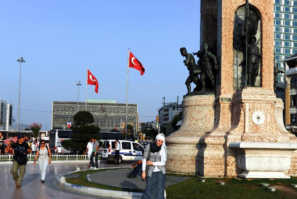 People walk at Taksim Square, considered the city's main business and entertainment center that hosts a monument to Turkey's ubiquitous national hero, Mustafa Kemal Ataturk, and other founders of the modern Turkish Republic, in Istanbul, Turkey, Monday, Oct. 28, 2013. Last summer, Istanbul’s Taksim Square was the scene of violent confrontations between police and protesters. But protests have faded, and contrary to some lingering perceptions, it’s quite calm now _ except for the normal hustle and bustle found in this vibrant city. And it’s as safe for tourists as it ever was. Istanbul is a thoroughly modern place, but it traces its roots back to 660 B.C. It’s the former seat of the opulent Byzantine and Ottoman empires and is divided into European and Asian sides by the Bosporus Strait, offering a wealth of history and stunning scenery.(AP Photo)