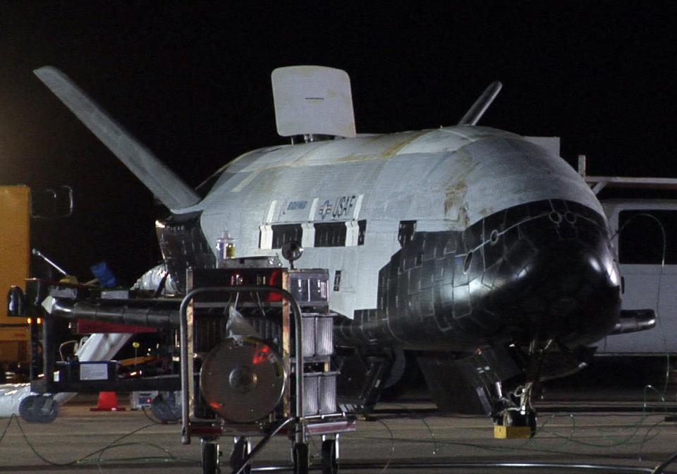 The U.S. Air Force's first unmanned re-entry spacecraft landed at Vandenberg Air Force Base in California, in this handout photo taken December 3, 2010, courtesy of U.S. Air Force. The U.S. Air Force will take over two mothballed space shuttle processing hangars at the Kennedy Space Center in Florida for its secretive X-37B robotic spaceplane program, NASA said on October 8, 2014. REUTERS/U.S. Air Force/Michael Stonecypher/Handout (UNITED STATES - Tags: SCIENCE TECHNOLOGY) FOR EDITORIAL USE ONLY. NOT FOR SALE FOR MARKETING OR ADVERTISING CAMPAIGNS. THIS IMAGE HAS BEEN SUPPLIED BY A THIRD PARTY. IT IS DISTRIBUTED, EXACTLY AS RECEIVED BY REUTERS, AS A SERVICE TO CLIENTS