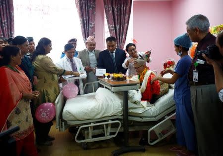 Taiwanese hiker Liang Sheng Yueh, who was lost in the Himalayas for over a month, celebrates his 21st birthday at a hospital after being rescued in Kathmandu, Nepal April 28, 2017. REUTERS/Navesh Chitrakar