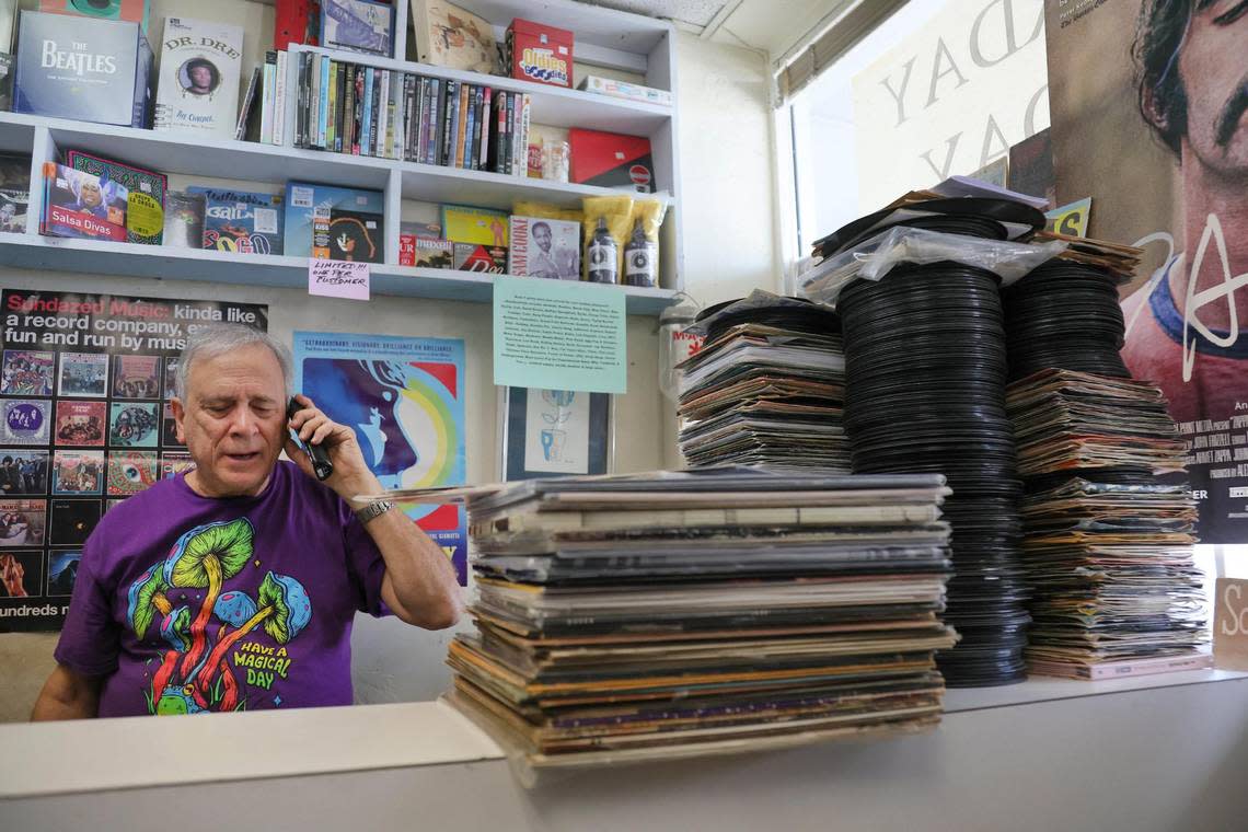 Yesterday and Today Records owner Evan Chern talks on the phone while working at his record store on west Bird Road at 9274 SW 40th St. in Miami, Florida, Friday, Feb. 2, 2024. Customers love talking music with this store owner.