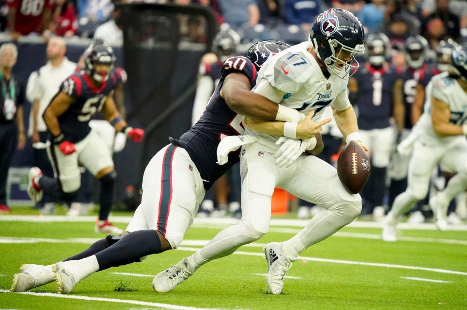 Tennessee Titans quarterback Ryan Tannehill (17) fumbles the ball as he is hit by Houston Texans defensive end Jordan Jenkins (50) during the third quarter at NRG Stadium Sunday, Jan. 9, 2022 in Houston, Texas.