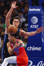 Oklahoma City Thunder guard Tre Mann (23) passes the ball as Dallas Mavericks forward Dwight Powell defends during the first half of an NBA basketball game, Monday, Jan. 17, 2022, in Dallas. (AP Photo/Brandon Wade)