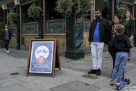 A 'Eat out to help out' sign stands outside a pub in the area of Notting Hill, in London, Monday, Aug. 31, 2020. Today is the last day of the 'Eat out to help out' scheme, the UK Government's initiative to support restaurants, cafés, bars and pubs. (AP Photo/Alberto Pezzali)