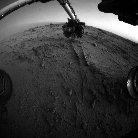 This image shows the view from NASA's Mars rover Curiosity after it uses an autonomous proximity placement technique to place its tool-laden robotic arm on a rock science target called 'Darwin' during the 399th Martian day, or sol, of its missi