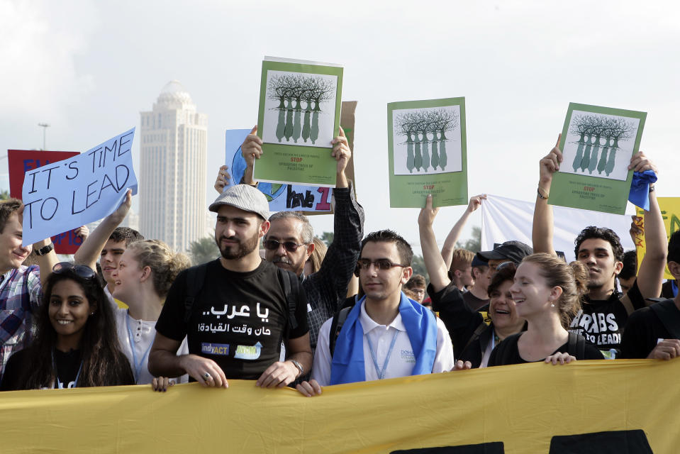 Local and international activists march to demand urgent action to address climate change at the U.N. climate talks in Doha, Qatar, Saturday , Dec. 1, 2012. (AP Photo/Osama Faisal)