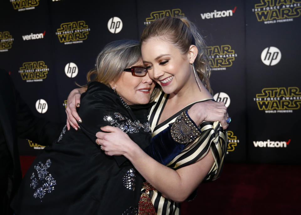 Actresses Carrie Fisher (L) and Billie Lourd embrace as they arrive at the premiere of 