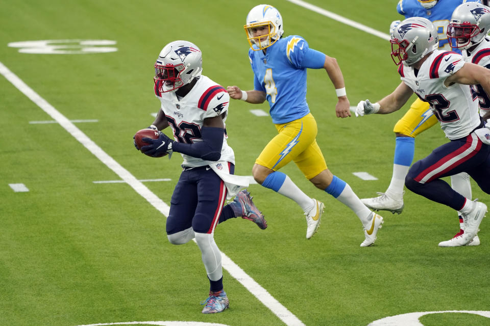 New England Patriots' Devin McCourty, left, returns a blocked field goal for a touchdown during the first half of an NFL football game against the Los Angeles Chargers Sunday, Dec. 6, 2020, in Inglewood, Calif. (AP Photo/Ashley Landis)