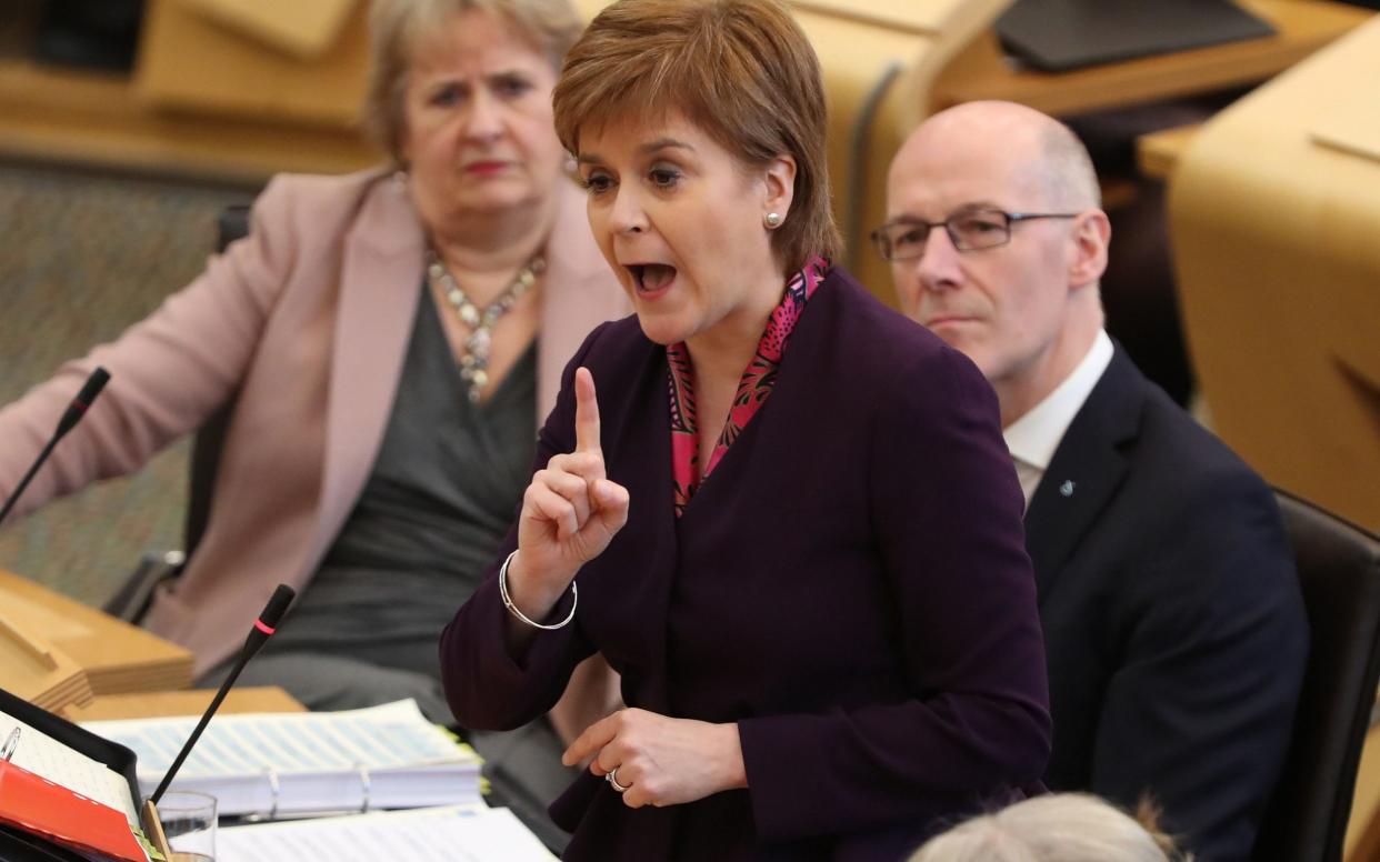 First Minister Nicola Sturgeon in the debating chamber during FMQs at the Scottish Parliament in Edinburgh - PA