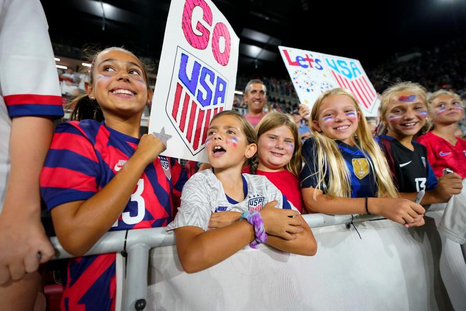 Young fans look on as they wait for members of the U.S. Soccer Federation, the U.S. Women's National Team Players Association and the U.S. National Soccer Team Players Association to sign a new collective bargaining agreements following the women's match against Nigeria at Audi Field, Tuesday, Sept. 6, 2022, in Washington.