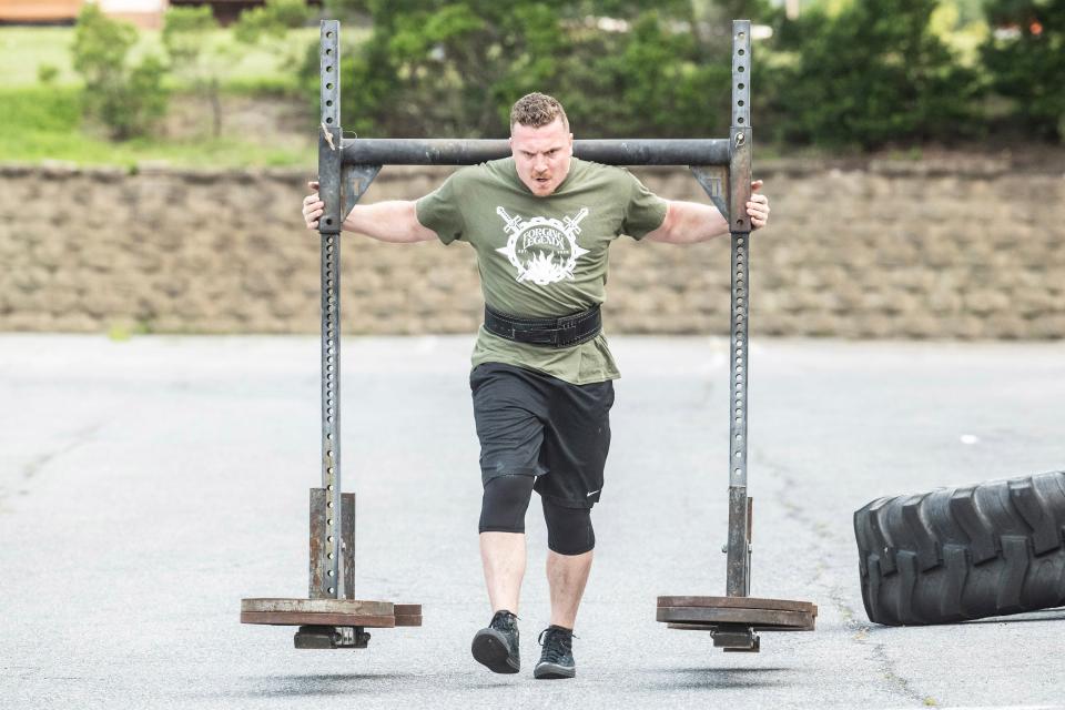 Bradie Crandall performs a Yoke walk with 550 pounds at the Training Center near New Castle on Thursday, Aug. 3, 2023. Crandall, a chemical engineering doctoral candidate at UD, is among the nation's top powerlifters and a vegan.