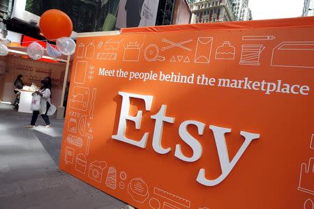 A sign advertising the online seller Etsy Inc. is seen outside the Nasdaq market site in Times Square following Etsy's initial public offering (IPO) on the Nasdaq in New York April 16, 2015. REUTERS/Mike Segar