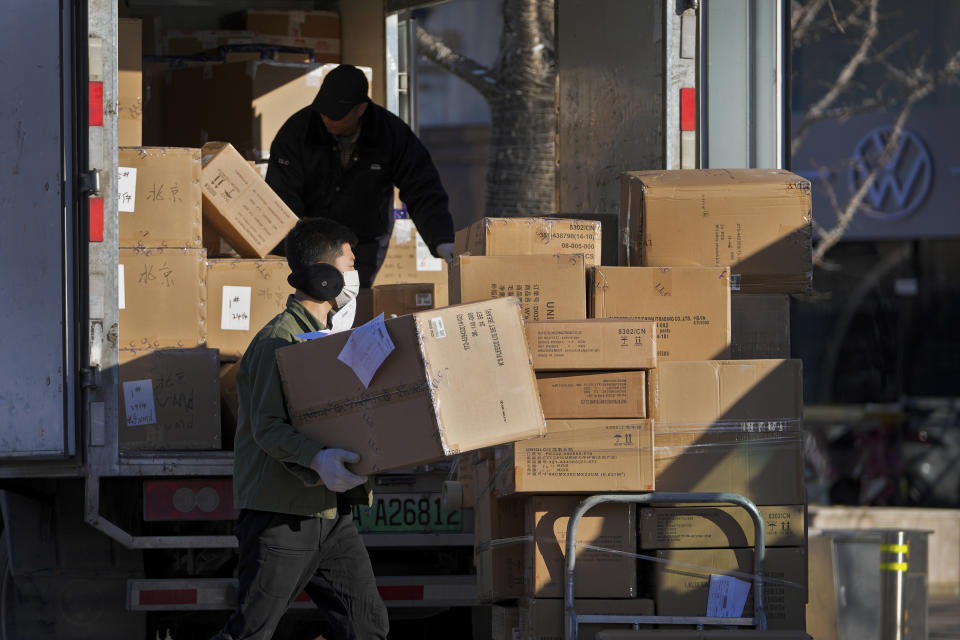 Workers load boxes of goods from a truck outside a shopping mall in Beijing on Monday, Dec. 6, 2021. China's exports rose in November over a year earlier, helped by recoveries in overseas markets, but growth was slower, while import growth picked up as demand recovered. (AP Photo/Andy Wong)