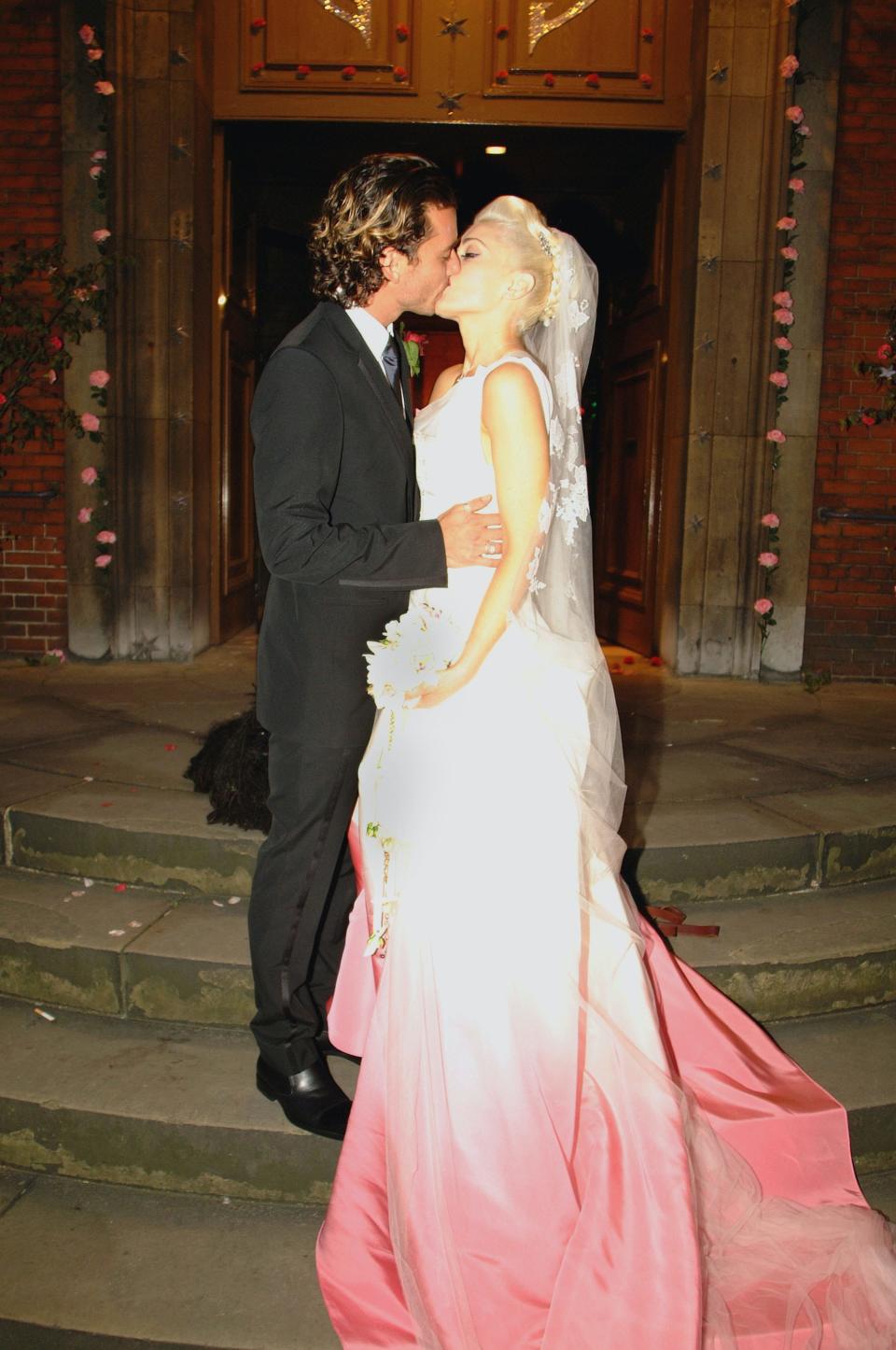 Gwen Stefani kisses Gavin Rossdale on their wedding day in 2002.