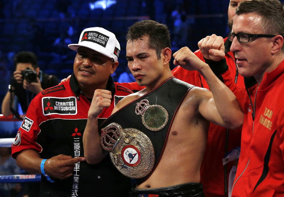 Nonito &quot;Filipino Flash&quot; Donaire of the Philippines celebrates after winning the WBA World Featherweight Title boxing match against Simpiwe Vetyeka of South Africa in Macau Saturday, May 31, 2014. Donaire defected Vetyeka. (AP Photo/Kin Cheung)