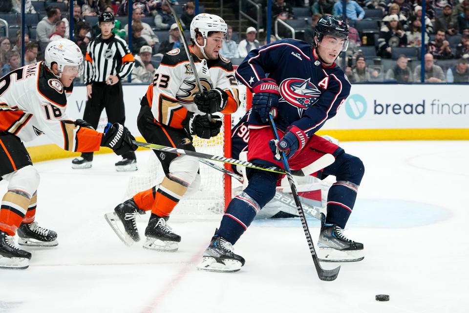 Oct 24, 2023; Columbus, Ohio, USA; Columbus Blue Jackets defenseman Zach Werenski (8) moves the puck away from Anaheim Ducks center Mason McTavish (23) during the second period of the NHL game at Nationwide Arena.