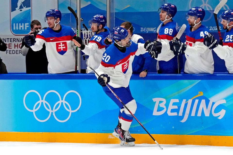 Slovakia forward Juraj Slafkovsky celebrates with teammates after opening the scoring in the first period.