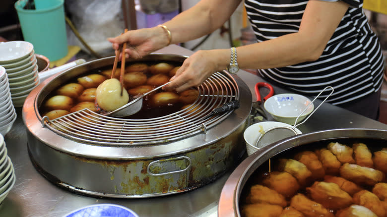 Woman deep frying Taiwanese meatballs