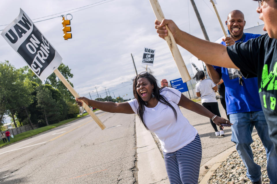 Flint resident Dorrit Madison, who has worked at the plant for more than 11 years, shouts out at cars passing by as General Motors employees demonstrate outside of the Flint Assembly Plant on Sunday, Sept. 15, 2019 in Flint. GM autoworkers in Lansing officially go on strike at midnight Sunday after UAW leadership voted to do so Sunday morning. (Jake May/The Flint Journal via AP)