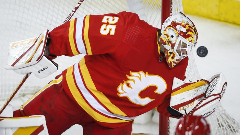 Calgary Flames goalie Jacob Markstrom eyes the puck during the third period of the team's NHL hockey game against the Vancouver Canucks on Saturday, Jan. 16, 2021, in Calgary, Alberta. (Jeff McIntosh/The Canadian Press via AP)