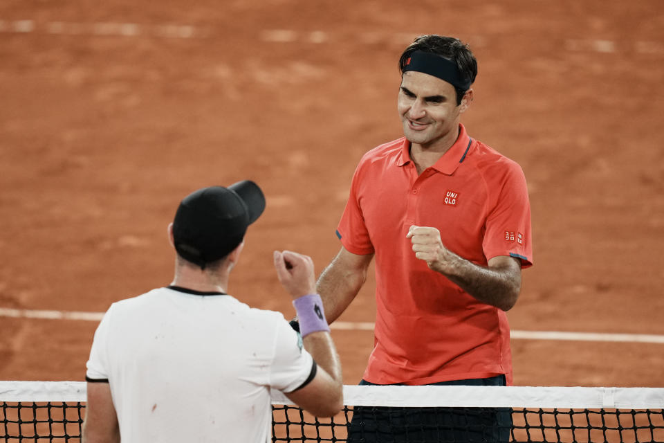 Switzerland's Roger Federer, right goes to shake hands with Germany's Dominik Koepfer, after defeating him in their third round match on day 7, of the French Open tennis tournament at Roland Garros in Paris, France, Saturday, June 5, 2021. (AP Photo/Thibault Camus)